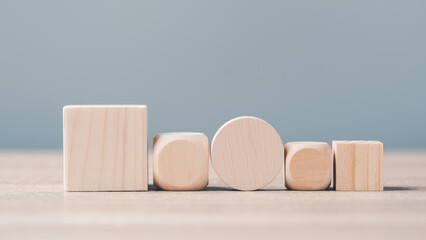 Wooden blocks of various sizes and shapes. arranged in an orderly row