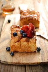 Rectangular pastry and delicious looking strawberries and blueberries on top