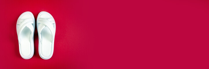 Women's summer white slippers on a red background. Slippers. Banner for insertion into site. Place for text cope space. Horizontal image