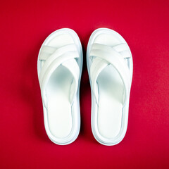 Women's summer white slippers on a red background. Slippers. Square image