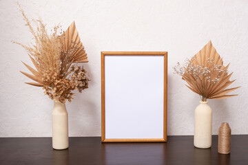 Mock up empty wooden frame mockup, dried leaf and pampass grass in vases on white background, interior, home design. Art concept. copy space