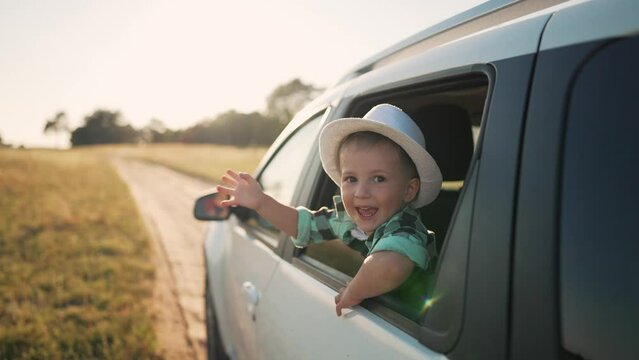 Happy family.Child in car window. Car family trip. Freedom and active holidays. Travel by car in nature. Cheerful smile of children. Kid smile and dream.Happy face in car window.Kids happiness concept