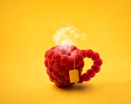 abstract photo of a cup of raspberry tea on a yellow background