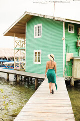 Young woman walking on pair looking left at bocas del toro Panama