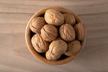 Whole walnuts on wooden background,top view