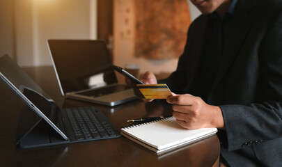 Manhands using smartphone and holding credit card with digital layer effect diagram as Online shopping concept.