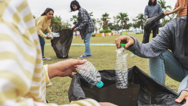 Asia Woman Group Team Volunteer Picking Up Trash Plastics Garbage Plastic Waste. Friend Putting Plastic Garbage Waste Into Bag At Park Concept Team Volunteer Charity Reduce Global Warming  Save Earth