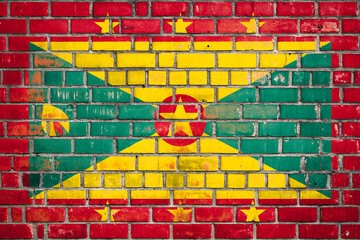 National  flag of the Grenada on a grunge brick background.