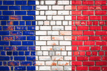 National  flag of the  France on a grunge brick background.