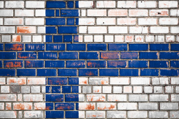 National  flag of the  Finland  on a grunge brick background.