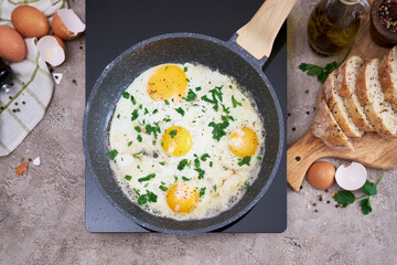 Fried Egg in cast iron frying pan on black induction hob