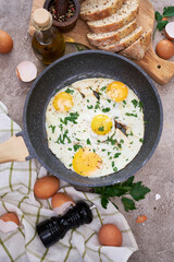Fried Egg in cast iron frying pan on black induction hob