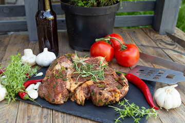 Marinated beef steak on wooden table top. Healthy food concept. Beef cut and spices for cooking bbq sauce outdoors, garden kitchen