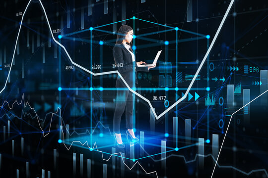 Thoughtful young european businesswoman with laptop standing inside abstract cube hologram on blurry blue background. Metaverse, software, future and data center concept. Double exposure.