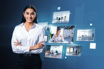 Happy young european businesswoman with folded arms and creative digital picture gallery on blue...