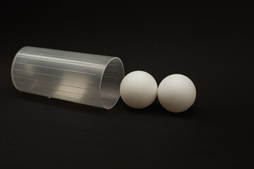 Table tennis balls on black background