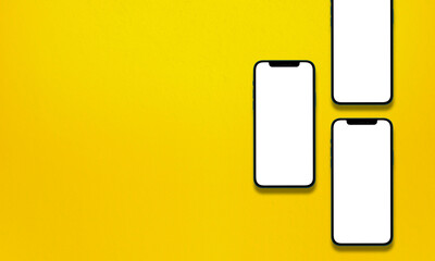 blank smartphones mockup over a yellow textured background