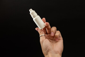 A girl is holding a vial of liquid in an urk - obrazy, fototapety, plakaty