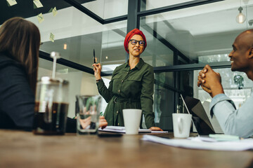 Businesswoman sharing her creative ideas with her colleagues
