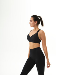 Fototapeta premium Perfect slim tanned young female body in sportswear. Concept perfect body, no fat, motivation, healthy lifestyle, fitness routine. Isolated white background.