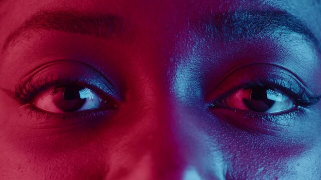 Native African American woman eyes, half-face portrait in neon light. Female person, pretty latin model sight.