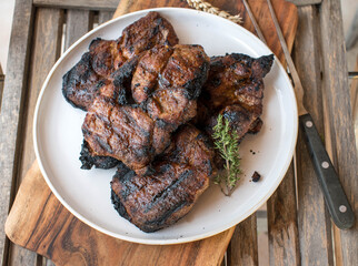 Fresh grilled pork neck steaks on a plate
