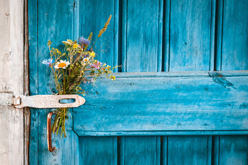 Flower bouqet on old farm house door