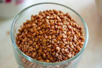 Buckwheat grains in the glass jar. Top view 