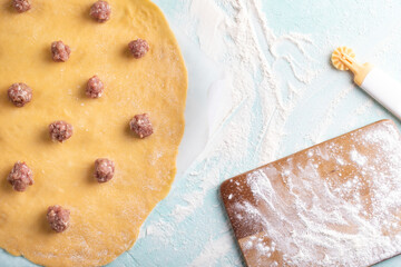 Making homemade ravioli, ravioli dough with meat.