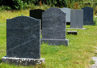 Graveyard with empty marble tombstones 