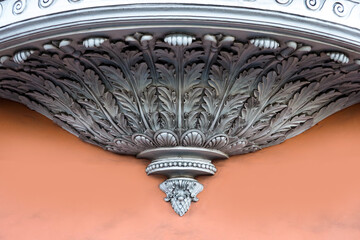 Bay window console with floral ornament. Architectural element on building facade, bas-relief....