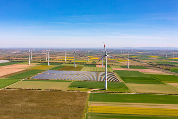 Aerial view of wind turbines and solar panels of a solar park on fields in Rhineland-Palatinate,...