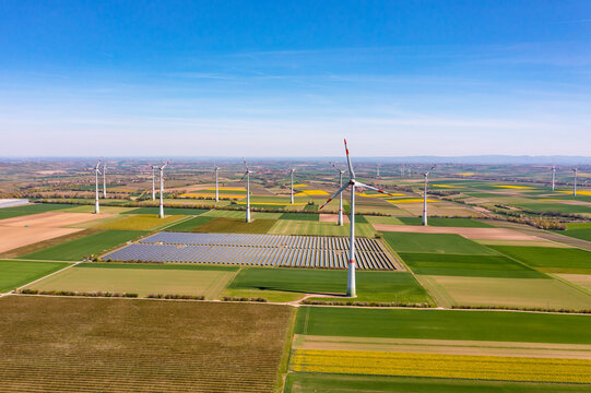 Aerial view of wind turbines and solar panels of a solar park on fields in Rhineland-Palatinate, Germany