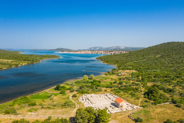 Ivinj archeological site with Saint Martin Church and town of Pirovac in background, Croatia