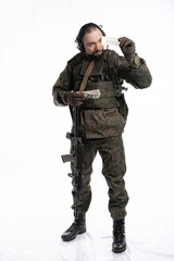 soldier in the studio on a white background. a man in military uniform with a rifle or machine gun. military or airball player