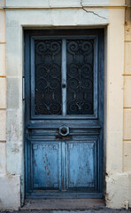 Old blue grungy door in the the south of France.