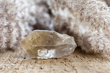 quartz with rutile crystal mineral stone on wood - obrazy, fototapety, plakaty