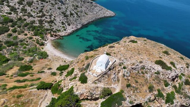 Aerial view of the small beach of Armeas next to Galissas with the picturesque church of Agios Pakos, Syros island, Cyclades, Greece