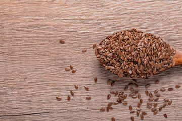 Flax seeds in a wooden spoon. Healthy whole grain food.