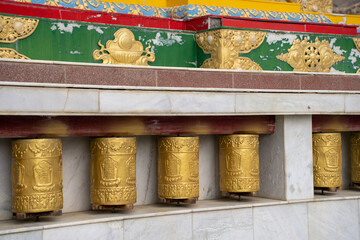 Tibetan metal prayer wheels with mantras at Spiti valley.