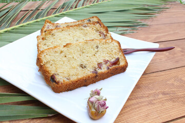 Gluten-free cake recipe with date fruit on palm and rustic wooden background