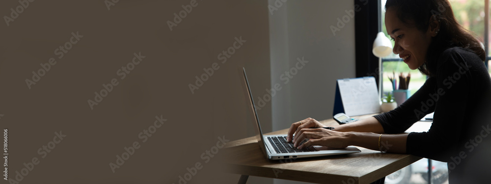 Wall mural remote working from home concept. hand of planner typing online via laptop. asian woman watching web
