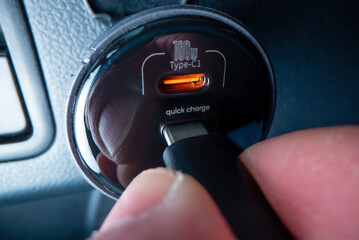Close-up view of plugging in USB type C cable into a powerful car charger - 518066658