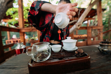 Young girl pouring water from cup close-up
