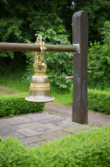 decorative golden bell hanging in the garden