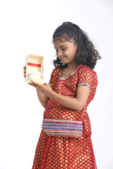 Indian little girl recieved gift and thinking some idea