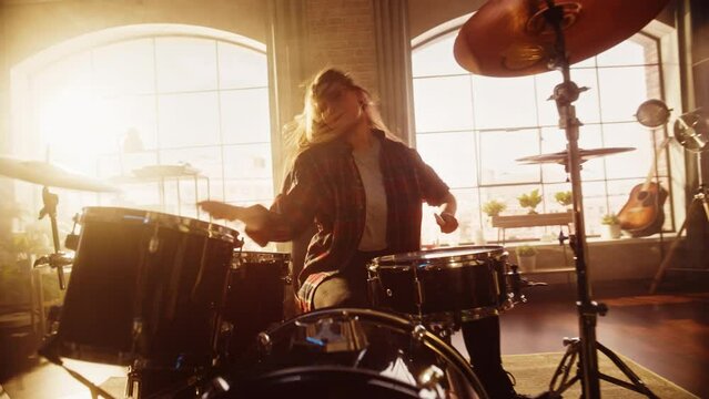 Expressive Drummer Girl Playing Drums in a Loft Music Rehearsal Studio Filled with Light. Rock Band Music Artist Learning a New Drum Solo. Zoom In Shot.