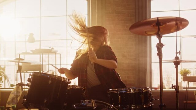 Beautiful Young Drummer Playing at a Band Rehearsal, Doing Tricks with Drumsticks. Learning Drum Solo on Drums and Cymbals in Sunny Living Room Loft Apartment. Slow Motion Portrait Footage.