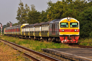 Obraz premium Passenger train by diesel locomotive on the railway in Thailand