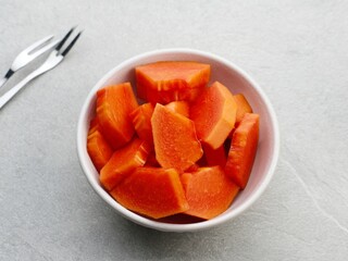 Healthy and fresh cut papaya fruit or sliced ​​papaya, served in a bowl
